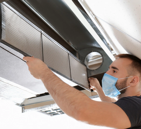 technician cleaning commercial ac